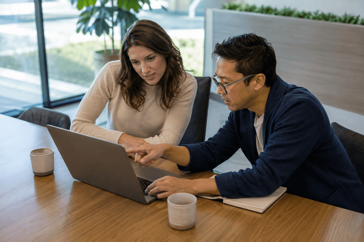 Colleagues reviewing product work in a bright meeting area